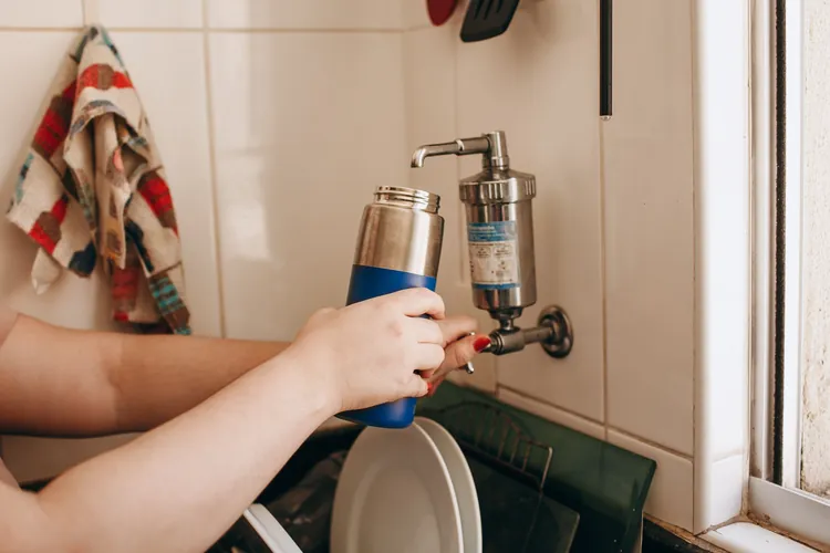 Filling a water bottle from a filter mounted on a kitchen faucet